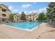Community pool with lounge chairs and a view of surrounding buildings at 9692 W Coco Cir # 304, Littleton, CO 80128