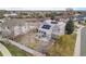 An aerial shot reveals a house with solar panels and a spacious backyard at 15907 W 72Nd Dr, Arvada, CO 80007