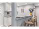 Wet bar features cabinets, sink, counter seating and granite countertop at 15907 W 72Nd Dr, Arvada, CO 80007