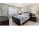 Comfortable bedroom with a large window, stylish lamps, and a cozy bed with decorative pillows at 15907 W 72Nd Dr, Arvada, CO 80007