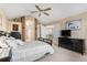 Vaulted ceiling bedroom featuring an ensuite bathroom, a ceiling fan, and warm neutral colors at 15907 W 72Nd Dr, Arvada, CO 80007