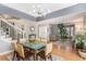 Open-concept dining area with modern chandelier and seamless flow into the living room at 15907 W 72Nd Dr, Arvada, CO 80007