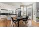 Bright dining area with hardwood floors and views of the backyard through large windows at 15907 W 72Nd Dr, Arvada, CO 80007