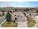 Two-story home features a brick-and-gray exterior with a well-manicured lawn and mountain views at 15907 W 72Nd Dr, Arvada, CO 80007