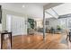 Bright foyer with hardwood floors, leading to the living area filled with natural light at 15907 W 72Nd Dr, Arvada, CO 80007