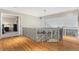Bright hallway featuring hardwood floors, decorative railing, and an open doorway to the bedroom at 15907 W 72Nd Dr, Arvada, CO 80007