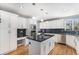 Modern kitchen with white cabinets, black granite countertops, and stainless steel appliances at 15907 W 72Nd Dr, Arvada, CO 80007