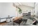 Spacious living room with high ceilings, a gray sectional, modern decor, and an open layout at 15907 W 72Nd Dr, Arvada, CO 80007