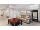 A cozy living room features a sectional sofa, recessed lighting, and stairs leading to upper level at 15907 W 72Nd Dr, Arvada, CO 80007