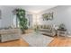 Comfortable living room with hardwood floors, neutral tones, and large windows for ample light at 15907 W 72Nd Dr, Arvada, CO 80007