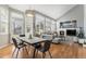 Spacious living room features a fireplace, hardwood floors, and natural light from large windows at 15907 W 72Nd Dr, Arvada, CO 80007