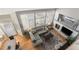 Top view of the sunlit living room features modern decor, a gray sofa, and a fireplace at 15907 W 72Nd Dr, Arvada, CO 80007