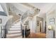 Elegant staircase with wrought iron railings and chandelier, adding a touch of sophistication at 15907 W 72Nd Dr, Arvada, CO 80007