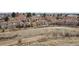 An aerial view showcasing the townhome community surrounded by greenbelts and walking paths at 17467 E Rice Cir # C, Aurora, CO 80015