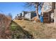 View of the backyard, featuring a sloping lawn and fencing, offering a private outdoor space at 17467 E Rice Cir # C, Aurora, CO 80015