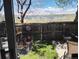 Private backyard patio area featuring a small garden, wooden fence and a view of the lake beyond at 17467 E Rice Cir # C, Aurora, CO 80015