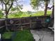 Private backyard with a wooden fence, stone patio, lush grass and garden with distant view at 17467 E Rice Cir # C, Aurora, CO 80015
