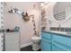 Colorful bathroom with blue vanity, granite countertop, tiled floor, and decorative accents at 17467 E Rice Cir # C, Aurora, CO 80015