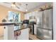 Modern kitchen featuring stainless steel appliances, white cabinets, and an island at 17467 E Rice Cir # C, Aurora, CO 80015