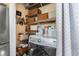 Functional laundry room with washer, shelving, and storage baskets, maximizing space at 17467 E Rice Cir # C, Aurora, CO 80015