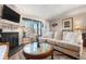 Inviting living room boasts a cozy fireplace, stylish decor, and bright window at 17467 E Rice Cir # C, Aurora, CO 80015