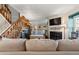Cozy living room featuring a fireplace, staircase, and comfortable seating at 17467 E Rice Cir # C, Aurora, CO 80015