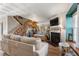 Inviting living room with cozy fireplace, elegant staircase, and comfortable seating area, perfect for relaxation at 17467 E Rice Cir # C, Aurora, CO 80015