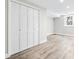 Unfurnished basement room with closet, wood flooring, and neutral walls, ready to customize at 4645 Quitman St, Denver, CO 80212
