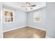 This light and airy bedroom features hardwood floors, two windows, and neutral paint at 4645 Quitman St, Denver, CO 80212