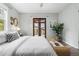 Bright bedroom features french doors to the outside, a woven bench, and neutral paint at 4645 Quitman St, Denver, CO 80212