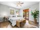 Serene bedroom with a queen bed, hardwood floors, a ceiling fan, and access to a private balcony at 4645 Quitman St, Denver, CO 80212