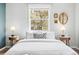 This neutral bedroom features end tables with lamps, minimalist decor, and a window to the outside at 4645 Quitman St, Denver, CO 80212