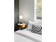 Bright bedroom features a side table with a lamp and a window to the outside at 4645 Quitman St, Denver, CO 80212
