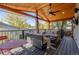 Inviting covered deck featuring wood ceiling, outdoor seating, ceiling fan, and stylish decor perfect for relaxation and entertaining at 4645 Quitman St, Denver, CO 80212