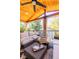 Inviting covered deck featuring wood ceiling, outdoor seating, curtains and stylish decor perfect for relaxation and entertaining at 4645 Quitman St, Denver, CO 80212