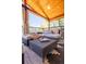 Inviting covered deck featuring wood ceiling, outdoor seating, curtains and stylish decor perfect for relaxation and entertaining at 4645 Quitman St, Denver, CO 80212