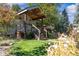 Attractive home featuring a covered front porch, lush greenery, and a welcoming entrance at 4645 Quitman St, Denver, CO 80212