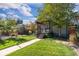 Beautiful home showcasing a well-maintained lawn, mature trees, and an inviting covered porch at 4645 Quitman St, Denver, CO 80212