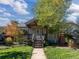 Charming home featuring a covered front porch and mature landscaping, exuding curb appeal at 4645 Quitman St, Denver, CO 80212
