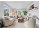 Bright living room featuring a curved white sofa, decorative coffee table, and views of outdoor scenery at 4645 Quitman St, Denver, CO 80212
