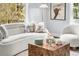 Close-up of living room featuring plush white sofa, decorative pillows, and a wooden coffee table at 4645 Quitman St, Denver, CO 80212