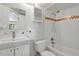 The bathroom features subway tile, a shower and tub, a modern sink, and a mirrored medicine cabinet at 5250 S Huron Way # 3-205, Littleton, CO 80120