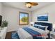 Charming bedroom with tufted headboard, blue accents, and natural light from the window at 5250 S Huron Way # 3-205, Littleton, CO 80120