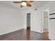 Bright bedroom features a modern ceiling fan, neutral walls, and hardwood floors at 5250 S Huron Way # 3-205, Littleton, CO 80120