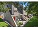Charming townhouse featuring a red door, inviting patio, and well-maintained landscaping at 5250 S Huron Way # 3-205, Littleton, CO 80120