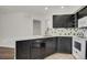 Bright kitchen features dark wood cabinets and white appliances with stylish countertops at 5250 S Huron Way # 3-205, Littleton, CO 80120