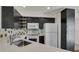 Modern kitchen featuring sleek, dark cabinets, stainless steel sink and white countertop at 5250 S Huron Way # 3-205, Littleton, CO 80120