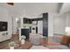 Open floorplan with modern kitchen featuring dark cabinets, white appliances and breakfast bar seating at 5250 S Huron Way # 3-205, Littleton, CO 80120