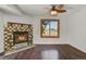 Cozy living room featuring a decorative fireplace, ceiling fan, and bright window at 5250 S Huron Way # 3-205, Littleton, CO 80120