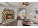 Cozy living room features a striking fireplace, comfortable seating, and natural light from the window at 5250 S Huron Way # 3-205, Littleton, CO 80120
